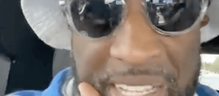 Man wearing sunglasses and a bucket hat.